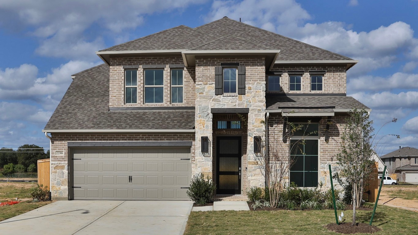 22306 Japanese Maple Lane Hockley, TX 77447 - Photo 1 of 18 a front view of a house with garden