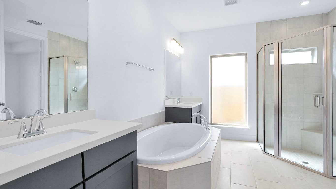 22306 Japanese Maple Lane Hockley, TX 77447 - Photo 14 of 18 a bathroom with a tub sink and mirror
