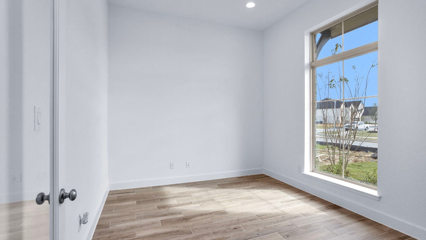 22306 Japanese Maple Lane Hockley, TX 77447 - Photo 8 of 18 a view of an empty room with wooden floor and a window