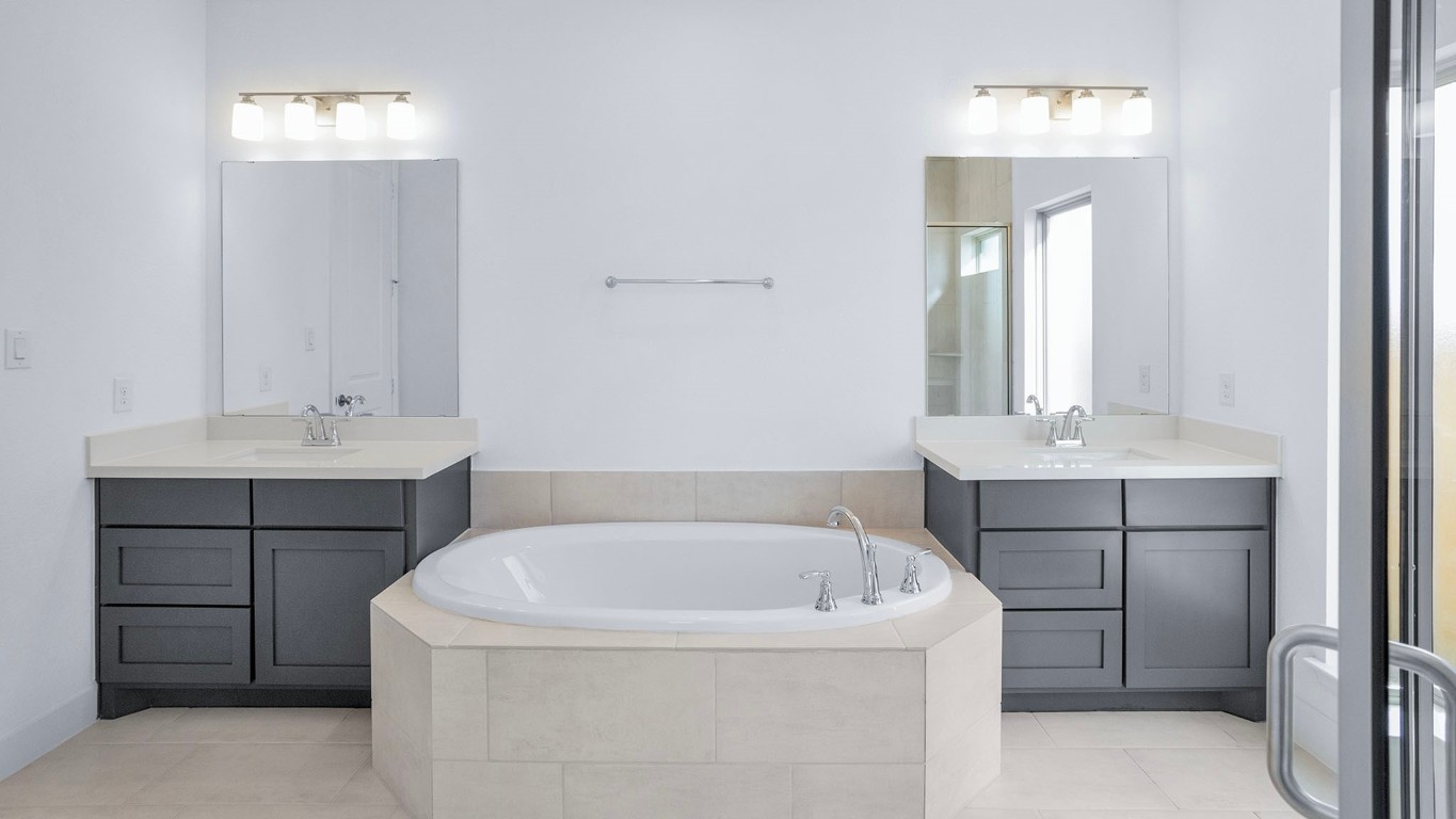 22306 Japanese Maple Lane Hockley, TX 77447 - Photo 9 of 18 a bathroom with a tub sink and mirror