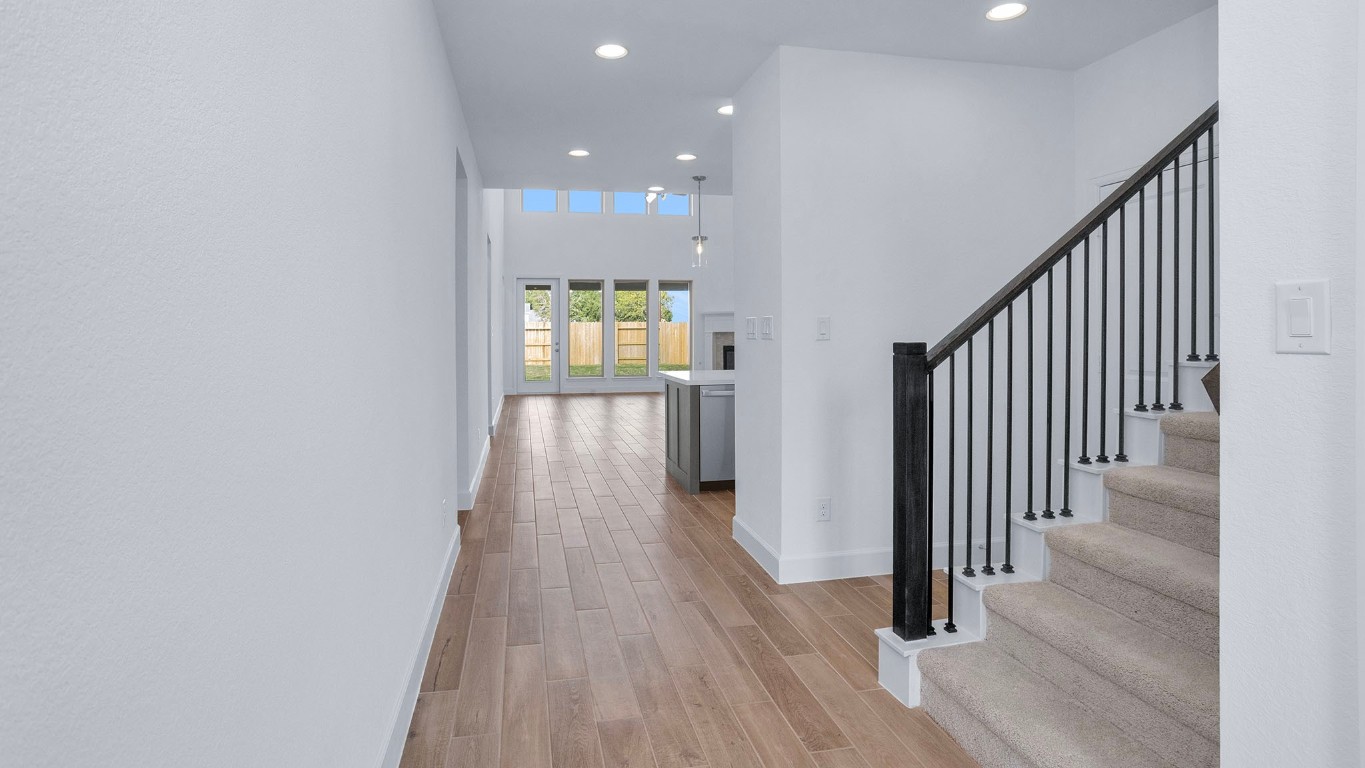 22306 Japanese Maple Lane Hockley, TX 77447 - Photo 10 of 18 a view of a hallway with wooden floor and staircase