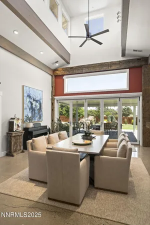 a kitchen with stainless steel appliances kitchen island granite countertop a table chairs stove and refrigerator