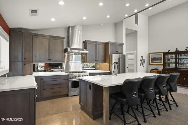 a kitchen with stainless steel appliances a stove sink and cabinets