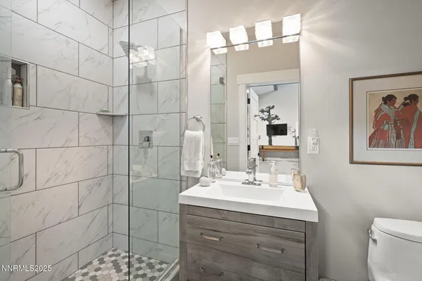 a spacious bedroom with a bed and a flat screen tv