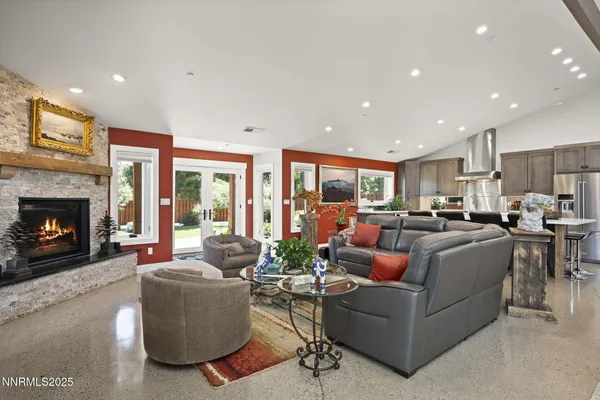 a living room with furniture a flat screen tv and a fireplace