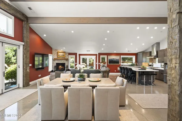 a dining room with furniture and a large window