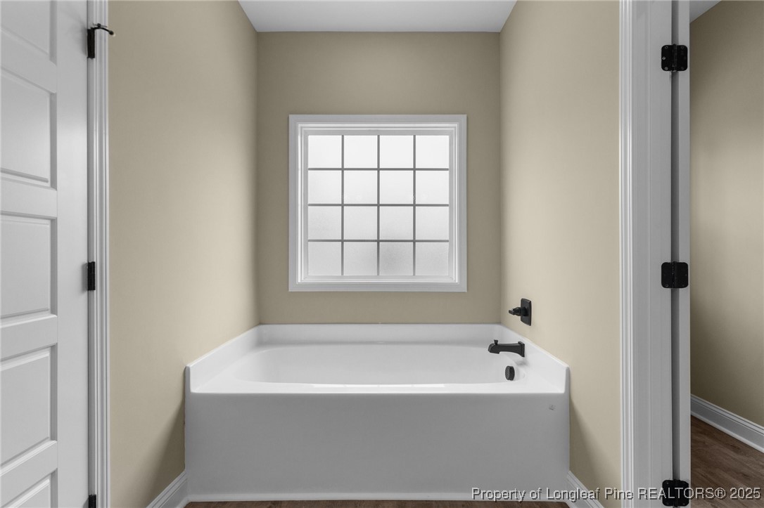 209 Mumford Road Raeford, NC 28376 - Photo 8 of 43 a white bath tub sitting next to a window
