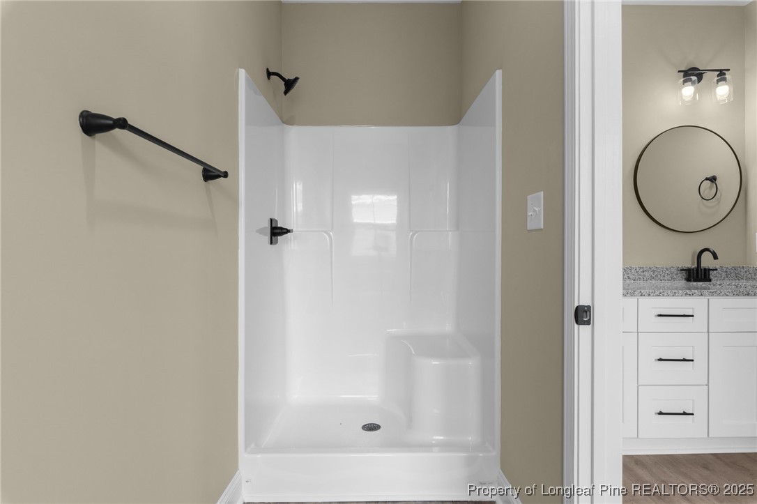209 Mumford Road Raeford, NC 28376 - Photo 10 of 43 a bathroom with a granite countertop sink mirror and shower