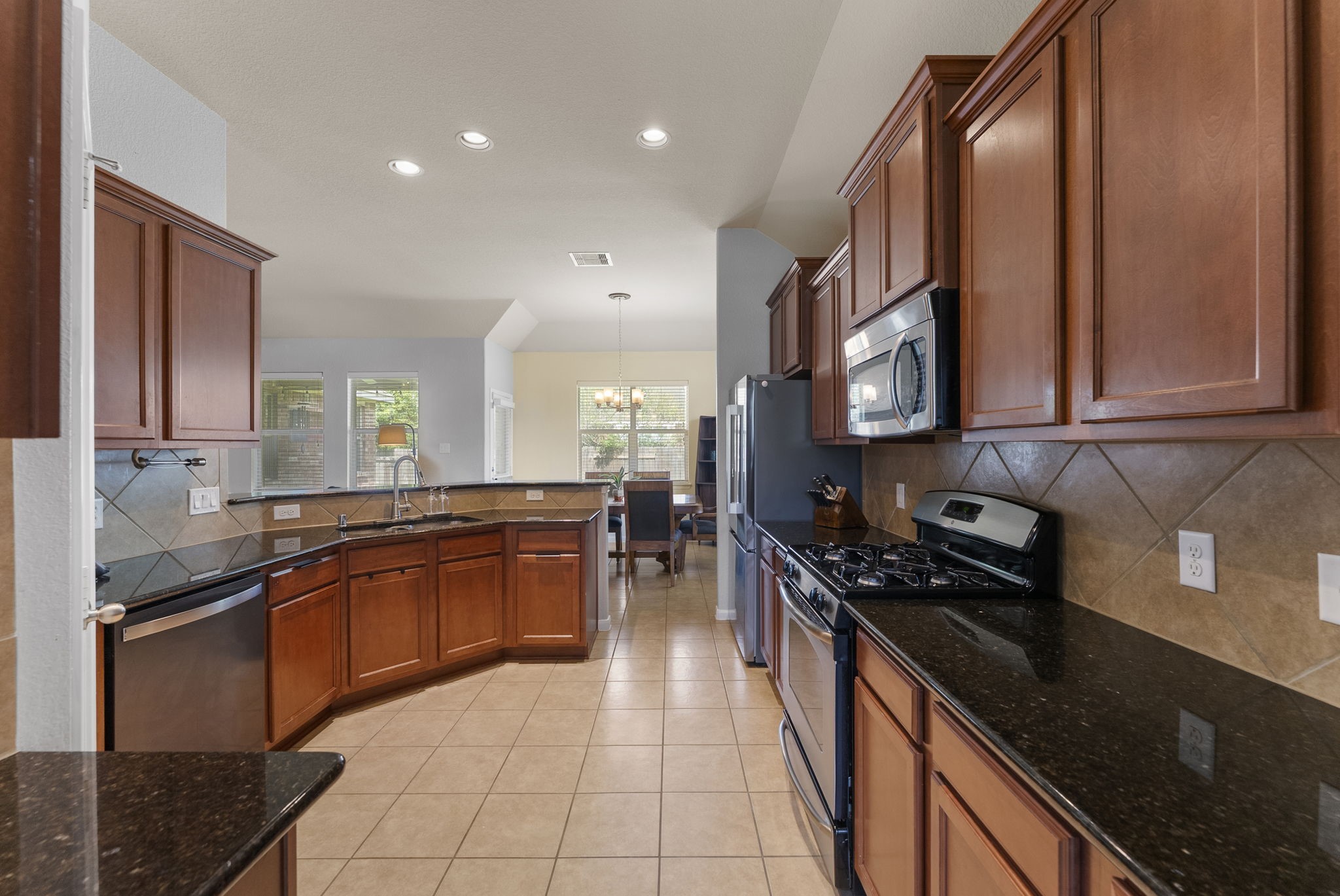 174 Maple Grove Drive Conroe, TX 77384 - Photo 7 of 26 Great kitchen layout offering plenty of cabinetry, generous countertop space, and a breakfast bar perfect for casual dining or morning coffee.