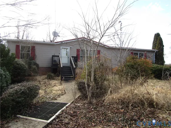 a view of a house with a yard and wooden fence