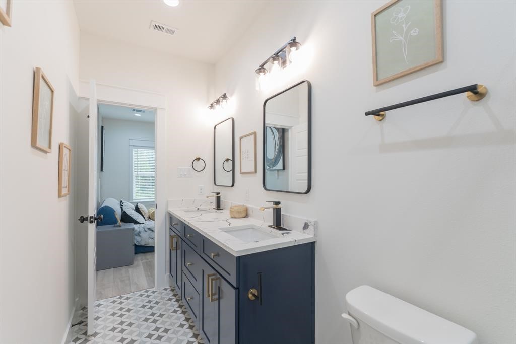 890 Lucky Street, Unit A Houston, TX 77088 - Photo 33 of 48 a bathroom with a double vanity sink toilet and shower