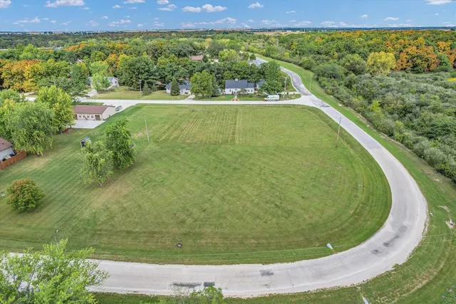 an aerial view of a residential houses with outdoor space