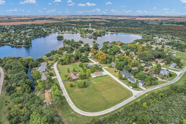 an aerial view of residential houses with outdoor space and trees