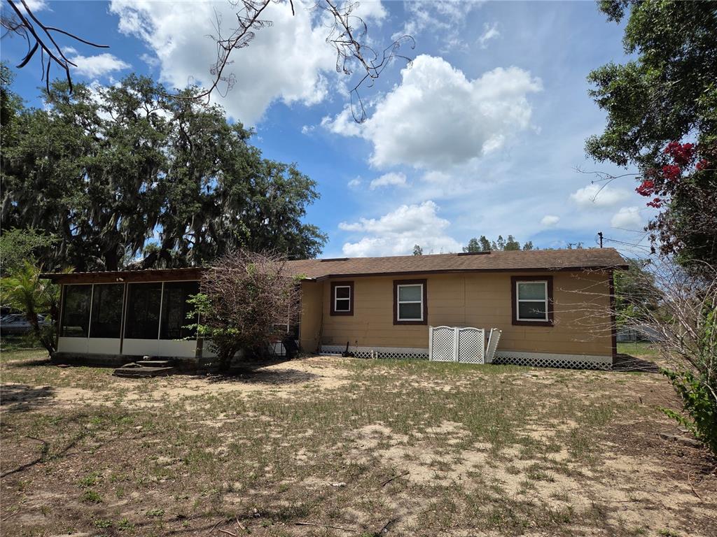 124 East F Street Frostproof, FL 33843 - Photo 35 of 37 a front view of house with yard and trees around