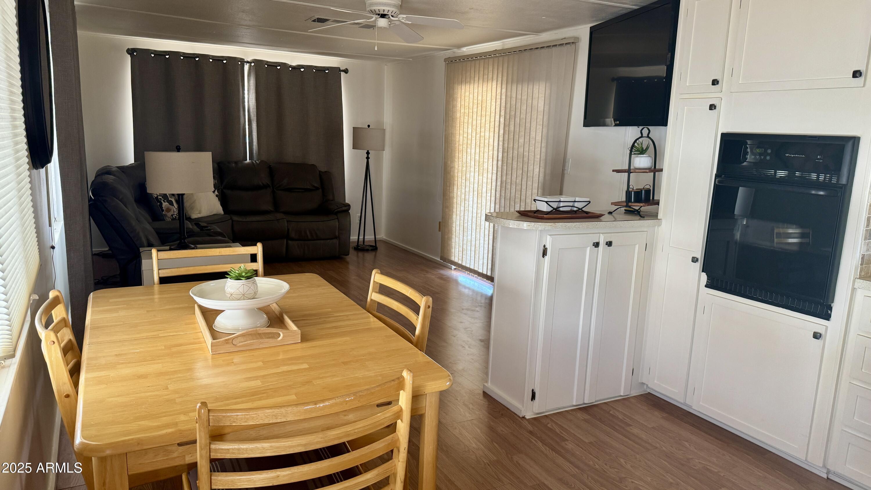 10220 East Apache Trail, Unit 52 Apache Junction, AZ 85120 - Photo 12 of 24 a kitchen with stainless steel appliances wooden floor and a refrigerator