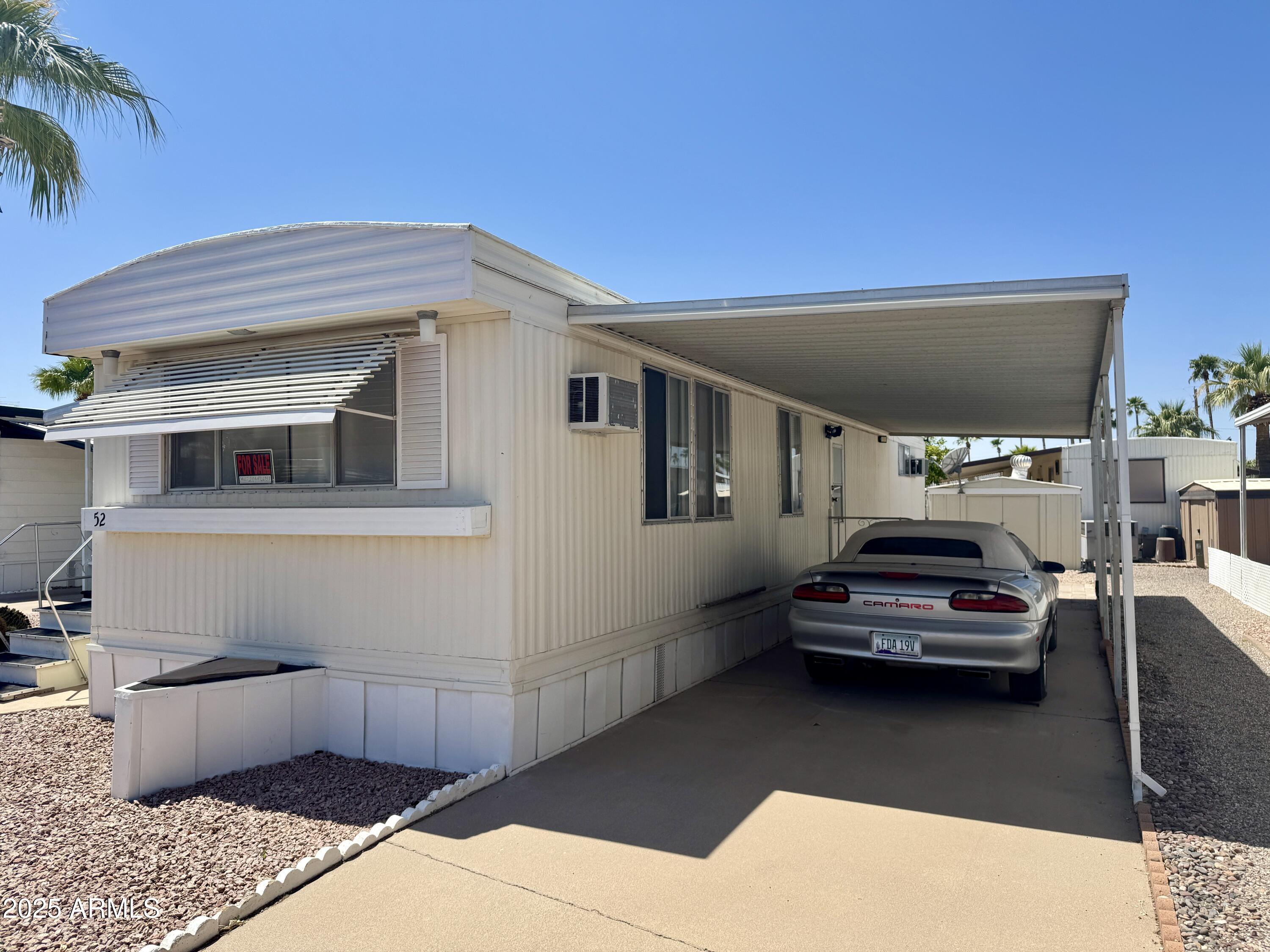 10220 East Apache Trail, Unit 52 Apache Junction, AZ 85120 - Photo 22 of 24 a view of a car parking