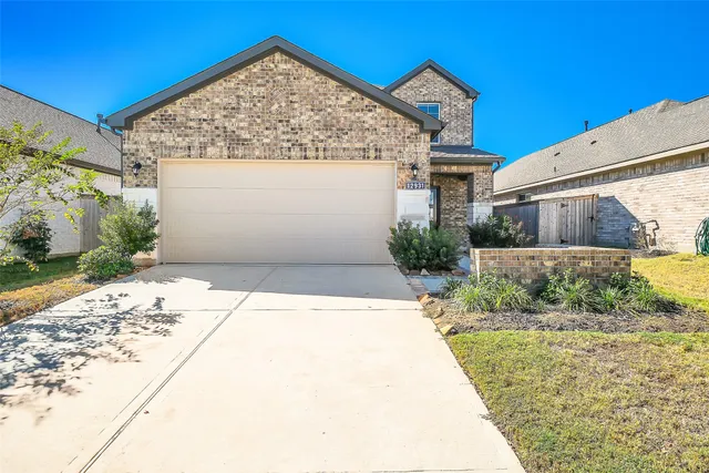 a view of a house with a small yard and potted plants