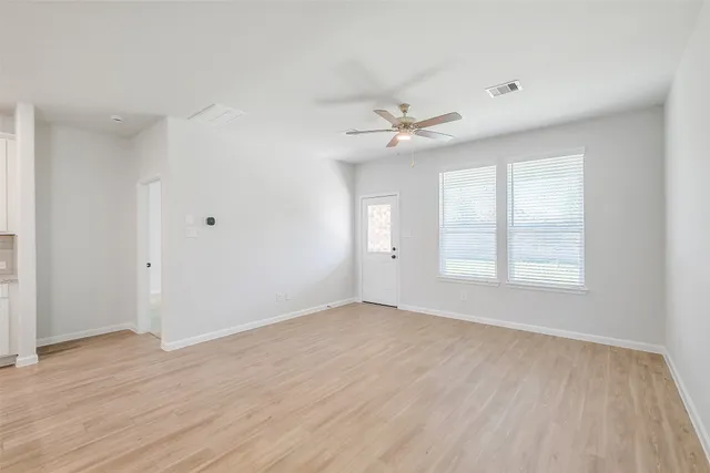 wooden floor in an empty room with a window