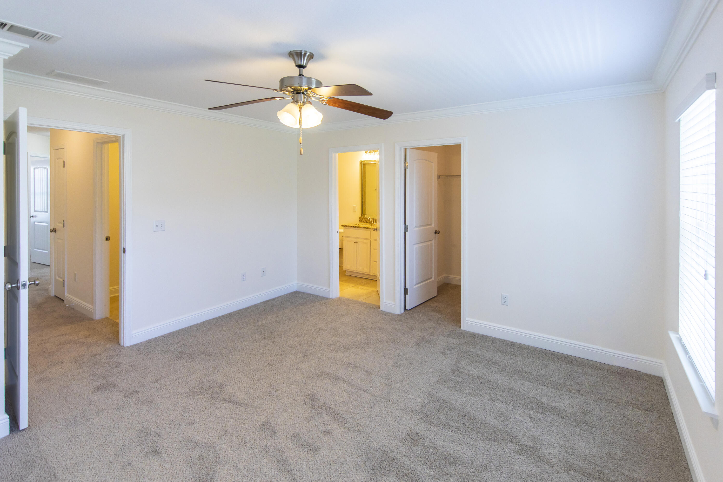 144 Grayling Way Inlet Beach, FL 32461 - Photo 17 of 19 an empty room with windows and chandelier fan