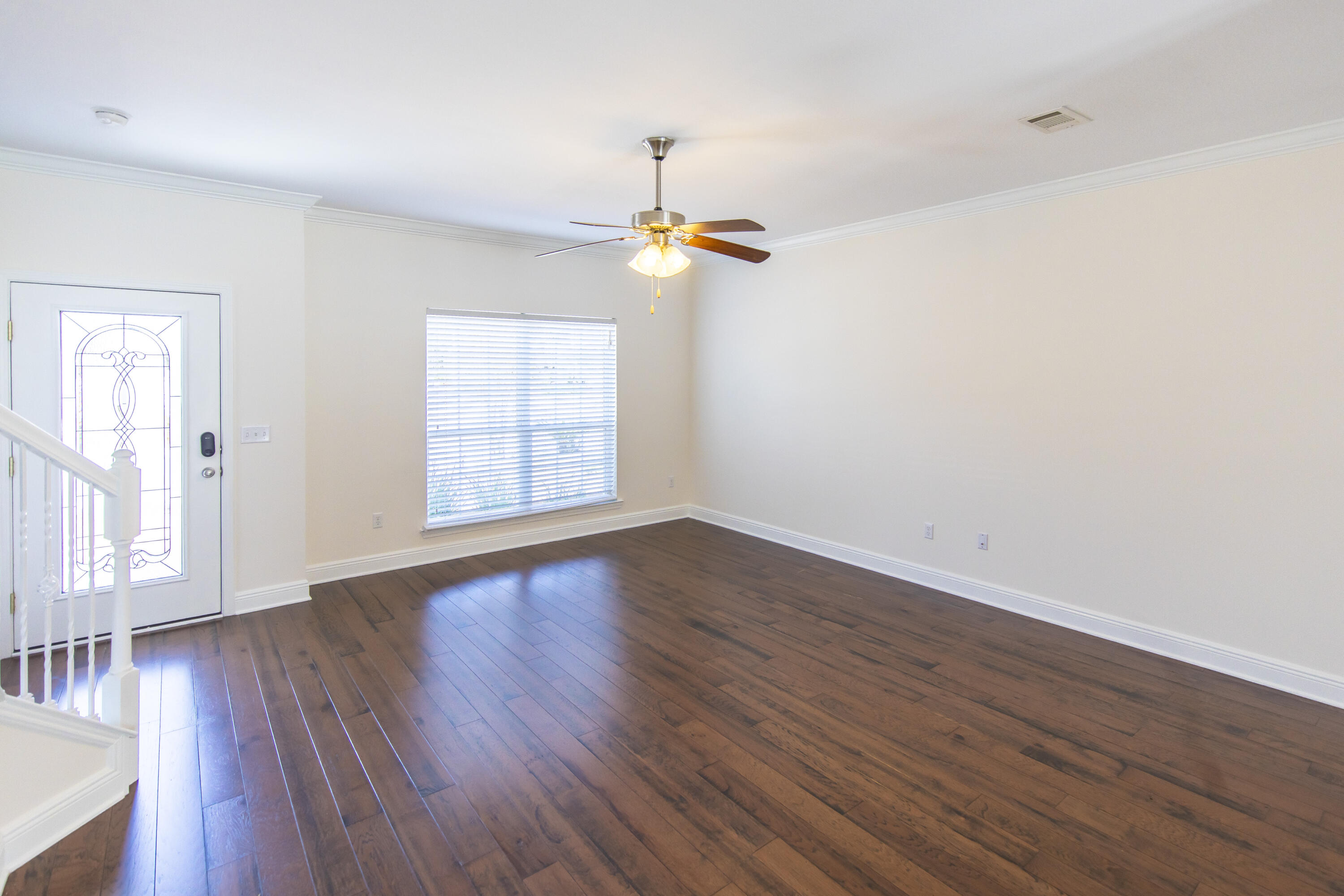 144 Grayling Way Inlet Beach, FL 32461 - Photo 7 of 19 an empty room with wooden floor ceiling fan and windows