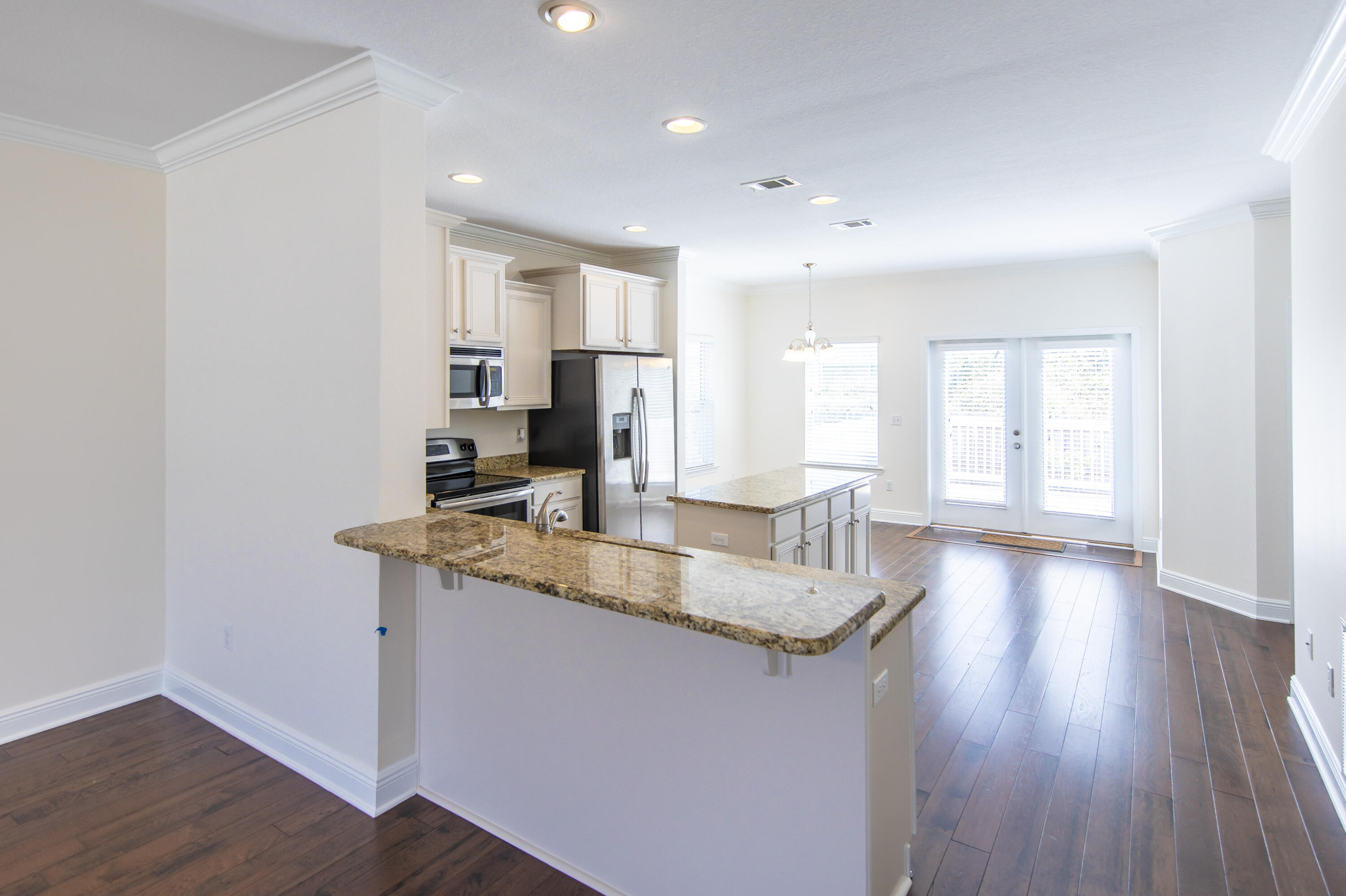 144 Grayling Way Inlet Beach, FL 32461 - Photo 9 of 19 a kitchen with kitchen island granite countertop a sink cabinets and wooden floor