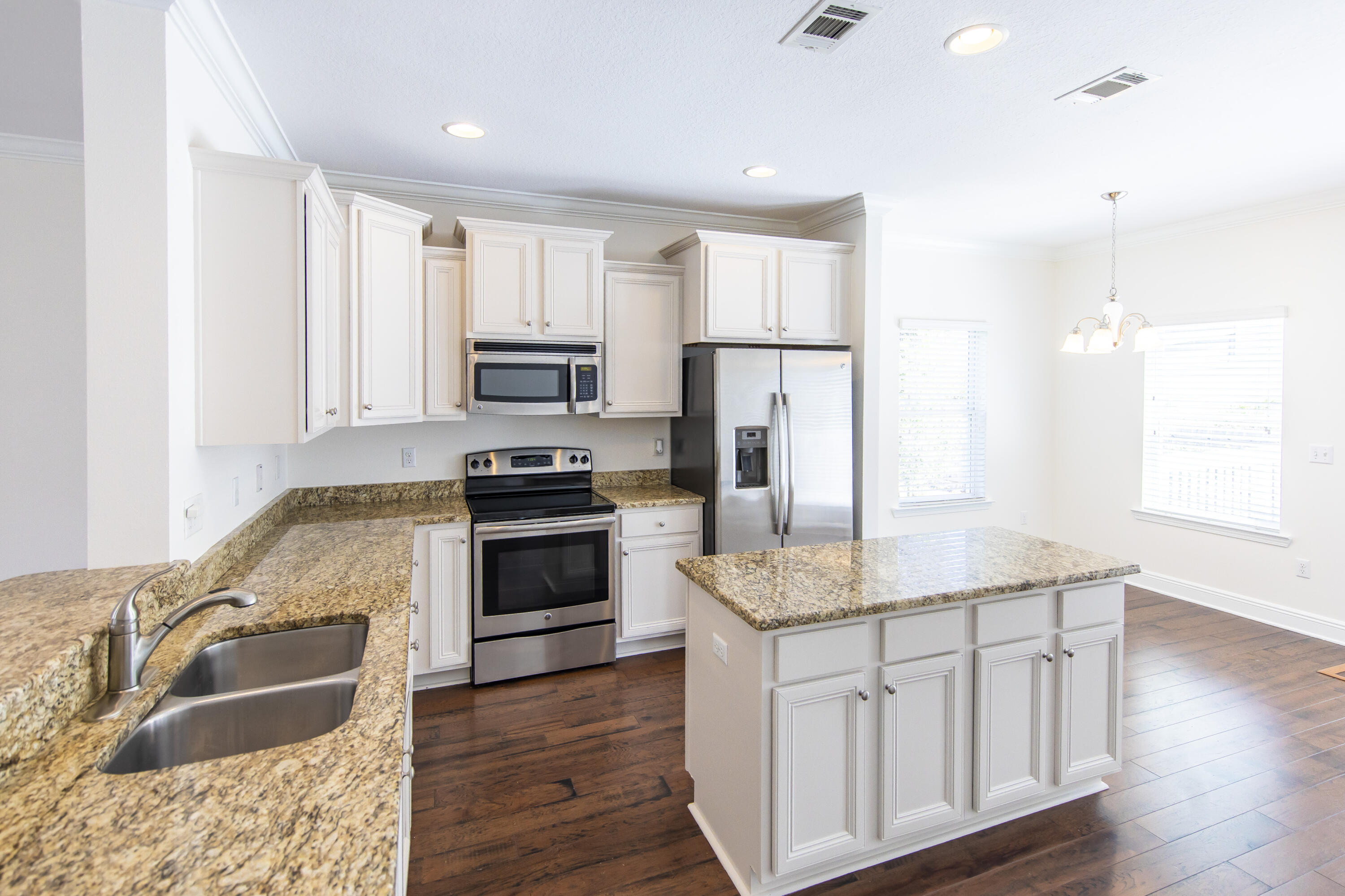 144 Grayling Way Inlet Beach, FL 32461 - Photo 10 of 19 a kitchen with granite countertop a sink stove and refrigerator