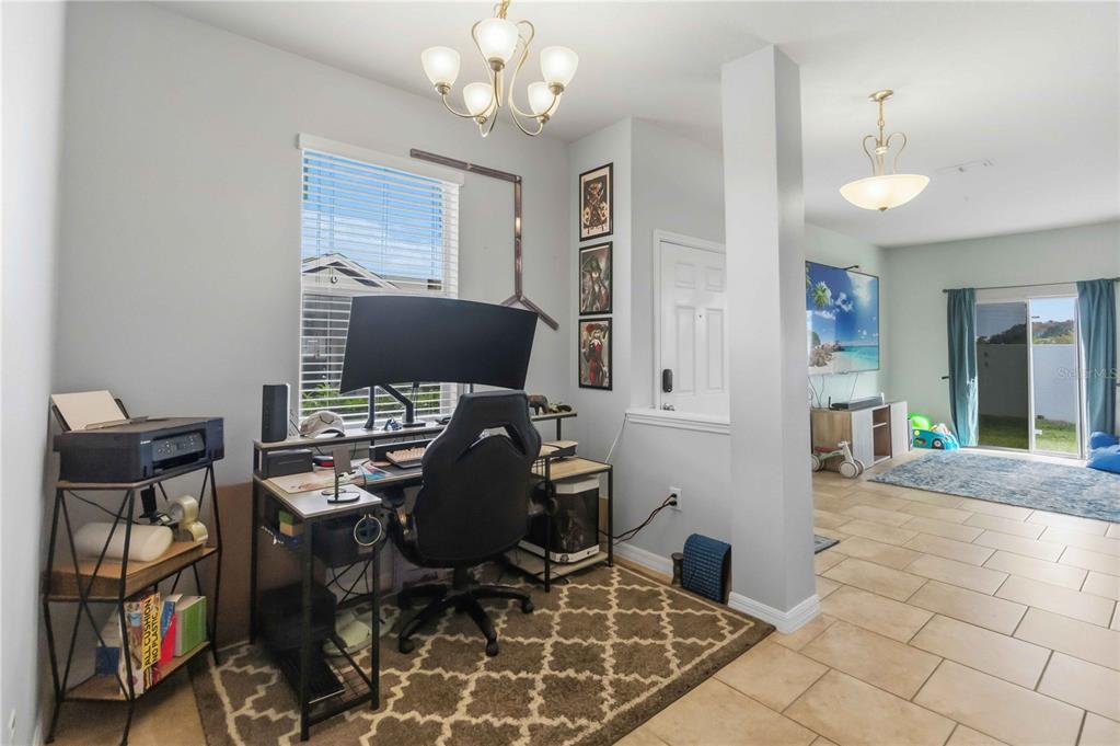 6560 South Goldenrod Road, Unit 79C Orlando, FL 32822 - Photo 14 of 36 a view of a workspace with furniture and a chandelier