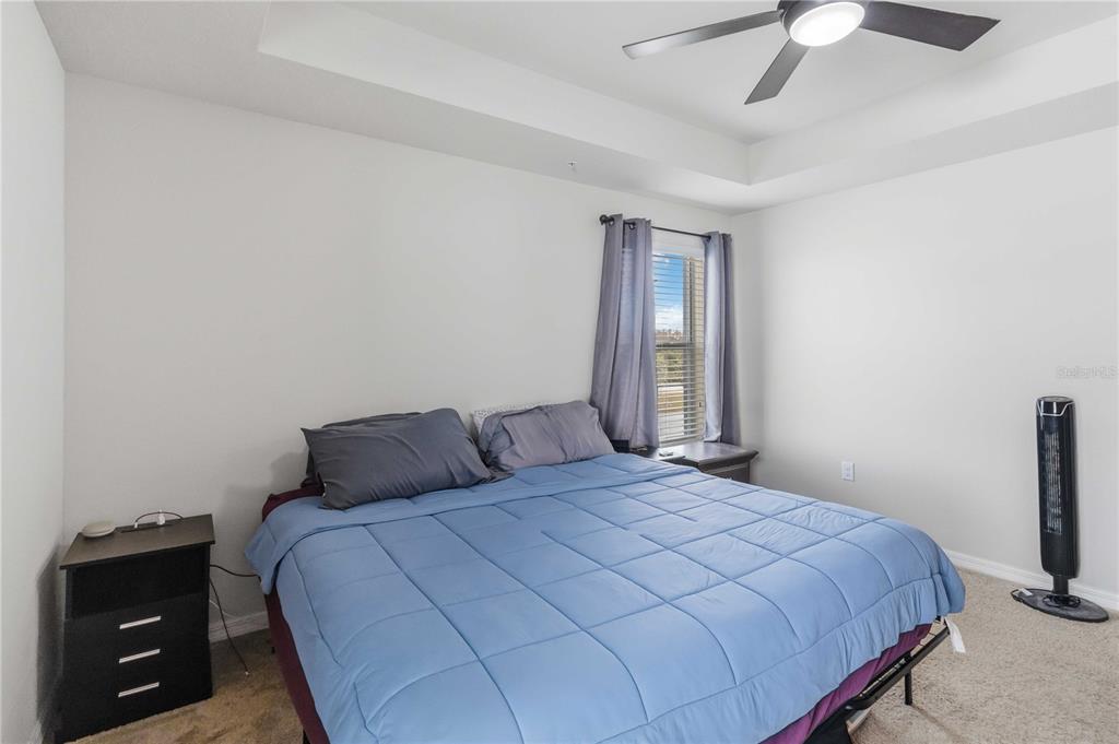 6560 South Goldenrod Road, Unit 79C Orlando, FL 32822 - Photo 19 of 36 a bedroom with a bed and a ceiling fan