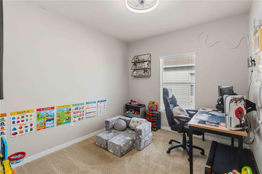 6560 South Goldenrod Road, Unit 79C Orlando, FL 32822 - Photo 25 of 36 a bedroom with furniture and a wooden floor