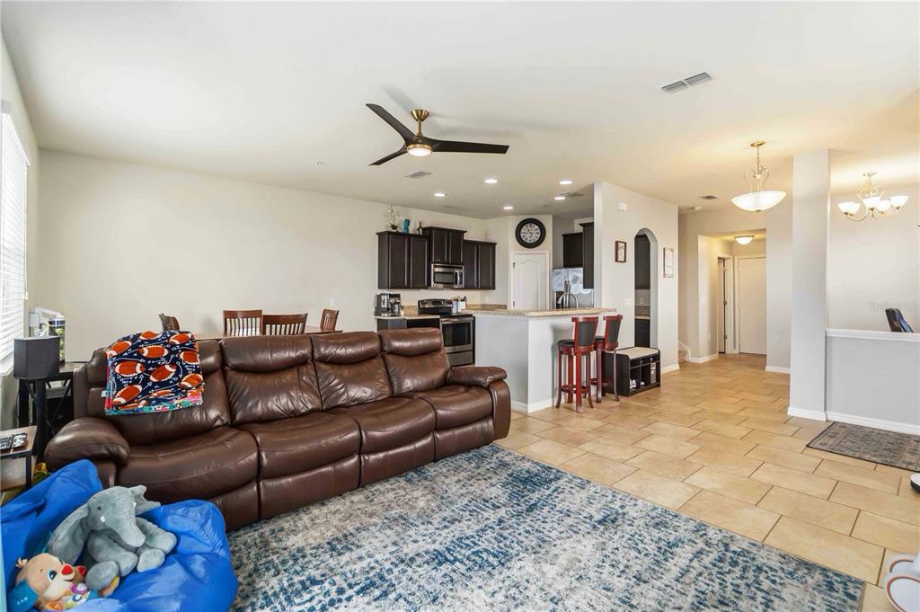 6560 South Goldenrod Road, Unit 79C Orlando, FL 32822 - Photo 6 of 36 a living room with furniture and a dining table with kitchen view
