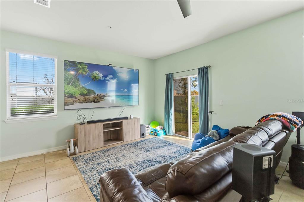 6560 South Goldenrod Road, Unit 79C Orlando, FL 32822 - Photo 7 of 36 a living room with furniture and flat screen tv