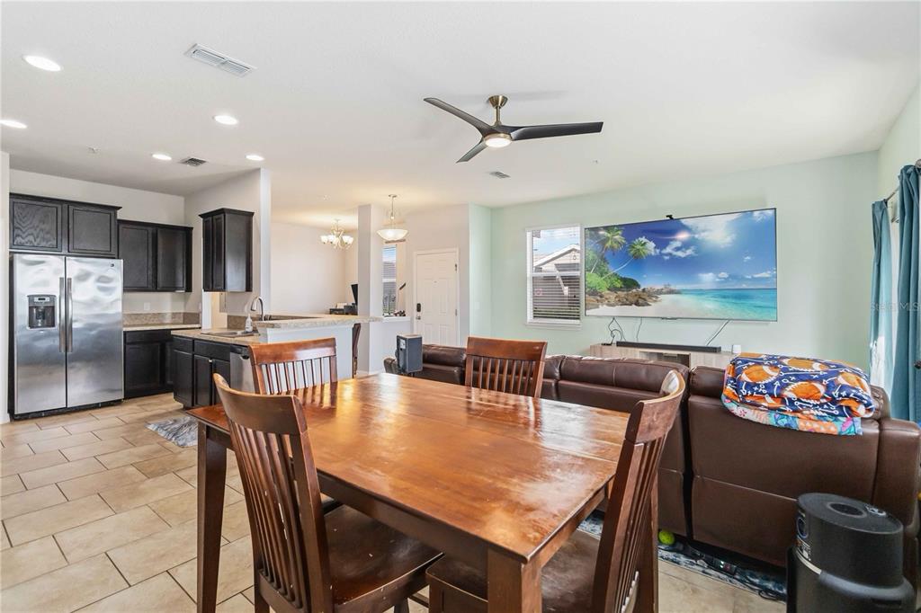 6560 South Goldenrod Road, Unit 79C Orlando, FL 32822 - Photo 8 of 36 a view of a dining room with furniture and a chandelier