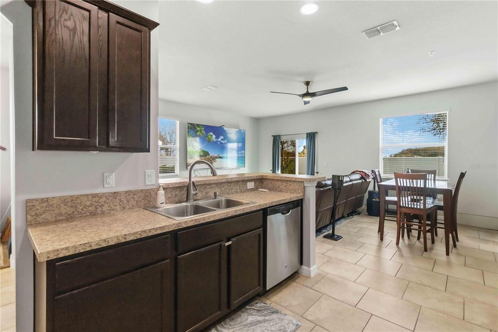 6560 South Goldenrod Road, Unit 79C Orlando, FL 32822 - Photo 10 of 36 a kitchen with a sink dining table and chairs