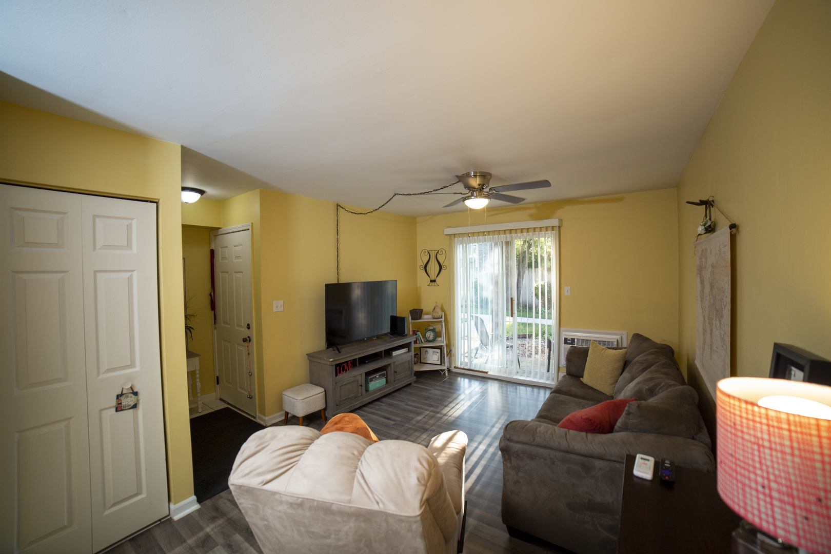 1900 Light Road, Unit 103 Oswego, IL 60543 - Photo 3 of 14 a bedroom with furniture and a flat screen tv