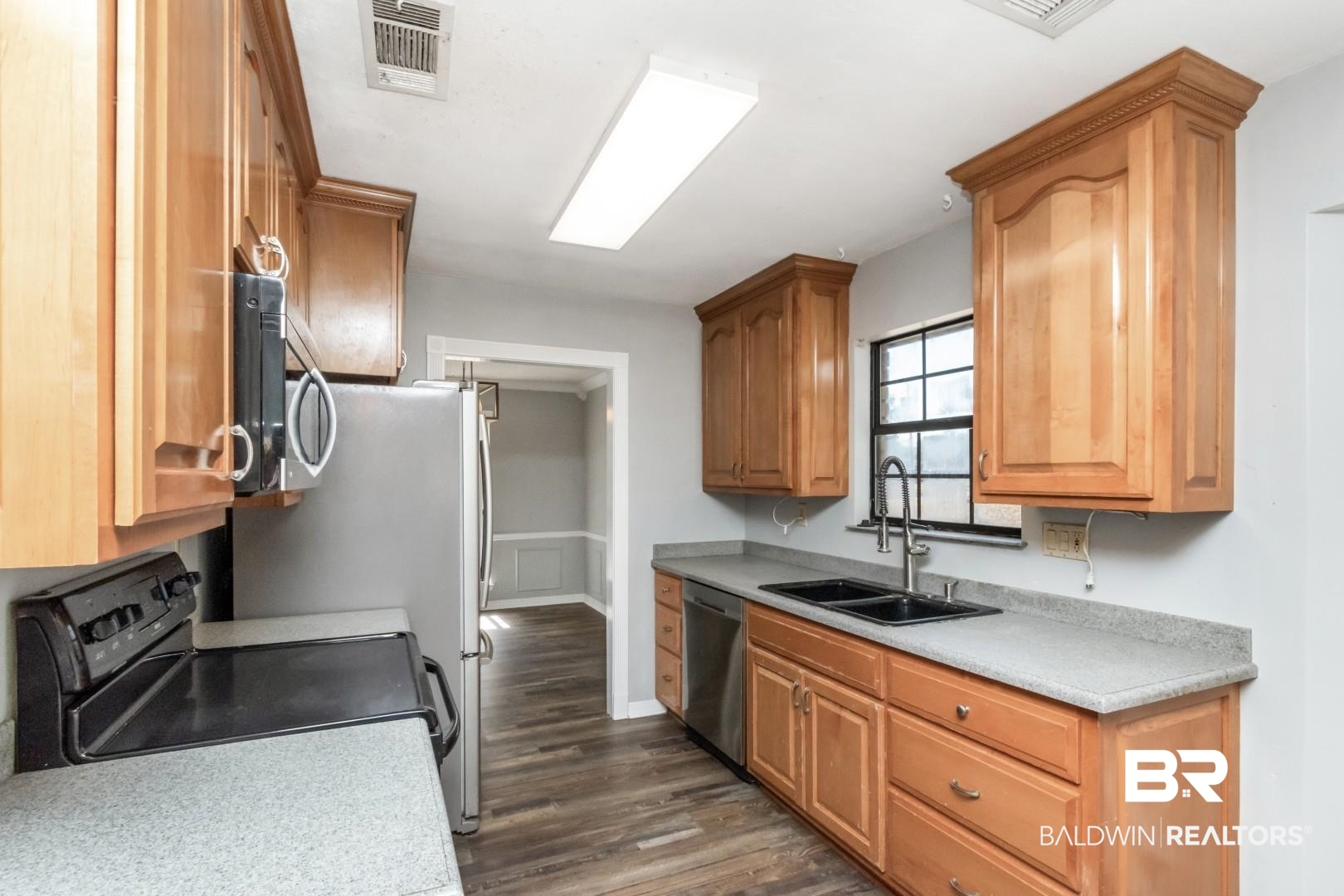 8304 Champlain Circle Mobile, AL 36695 - Photo 13 of 46 Kitchen featuring stainless steel appliances, dark hardwood / wood-style flooring, and sink