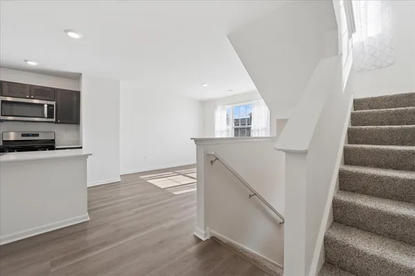 a view of kitchen and hallway with wooden floor
