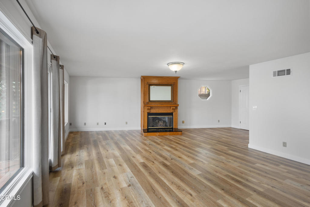 2524 Monaco Drive Oxnard, CA 93035 - Photo 12 of 50 a view of an empty room with wooden floor and a window