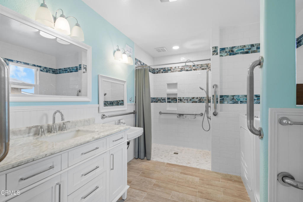2524 Monaco Drive Oxnard, CA 93035 - Photo 26 of 50 a bathroom with a shower sink and mirror
