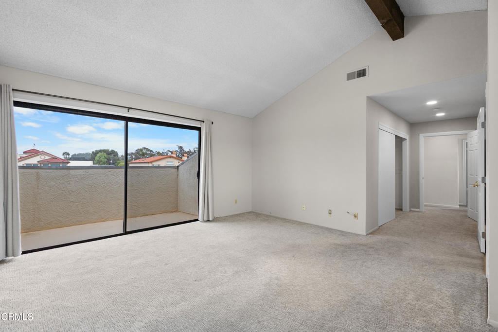 2524 Monaco Drive Oxnard, CA 93035 - Photo 31 of 50 an empty room with sliding glass door and chandelier