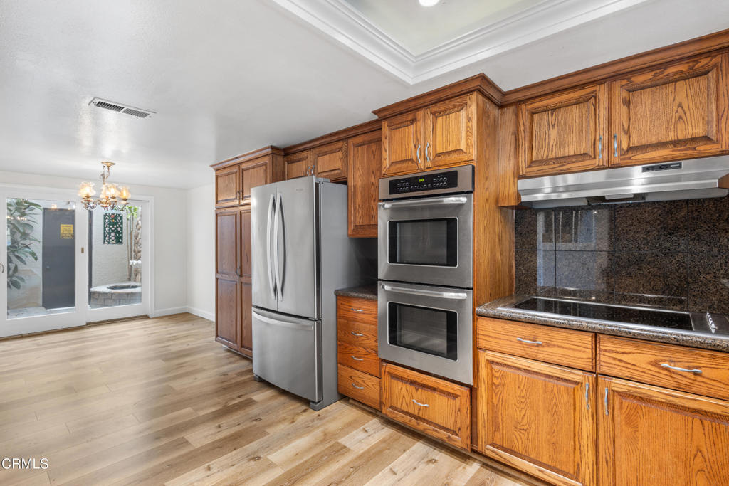 2524 Monaco Drive Oxnard, CA 93035 - Photo 6 of 50 a kitchen with stainless steel appliances granite countertop a refrigerator and a stove top oven