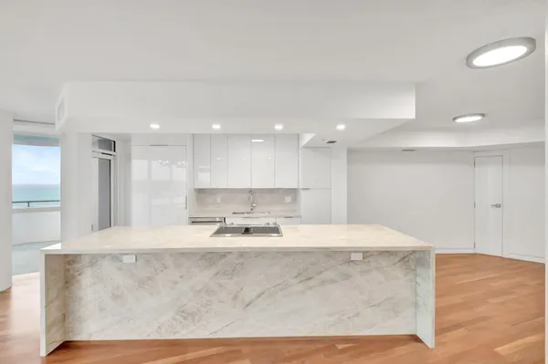 a kitchen with granite countertop a sink and stainless steel appliances