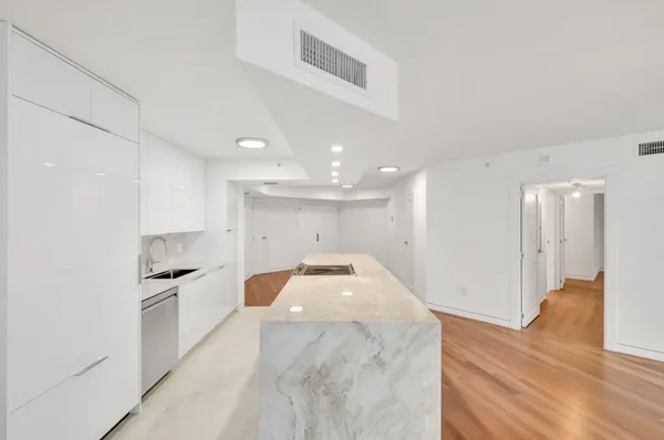 a bedroom with a bed and white cabinets
