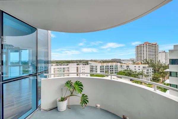a view of a balcony with floor to ceiling windows and floor