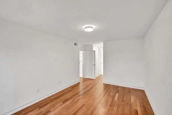 a bathroom with a toilet sink a mirror and vanity