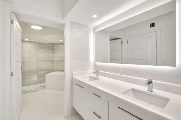 a bathroom with a toilet a sink and shower