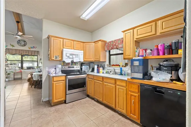 a kitchen with stainless steel appliances granite countertop a stove and a sink