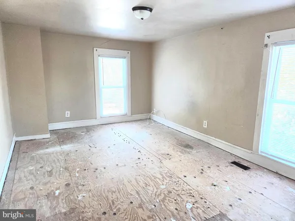 a view of a bedroom with wooden floor and bathroom
