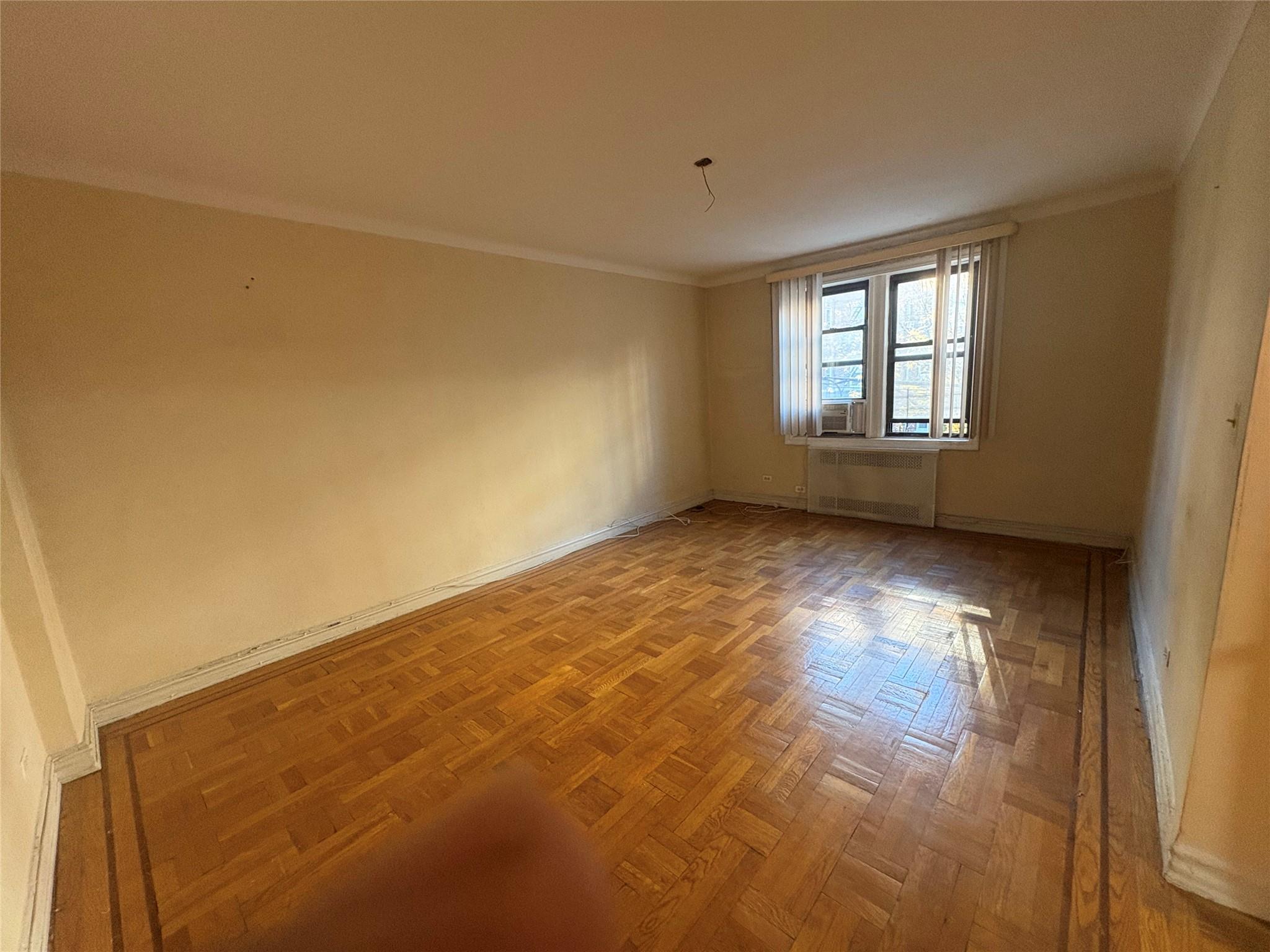 65-38 Booth Street, Unit 2F Queens, NY 11374 - Photo 11 of 13 a view of an empty room with a window