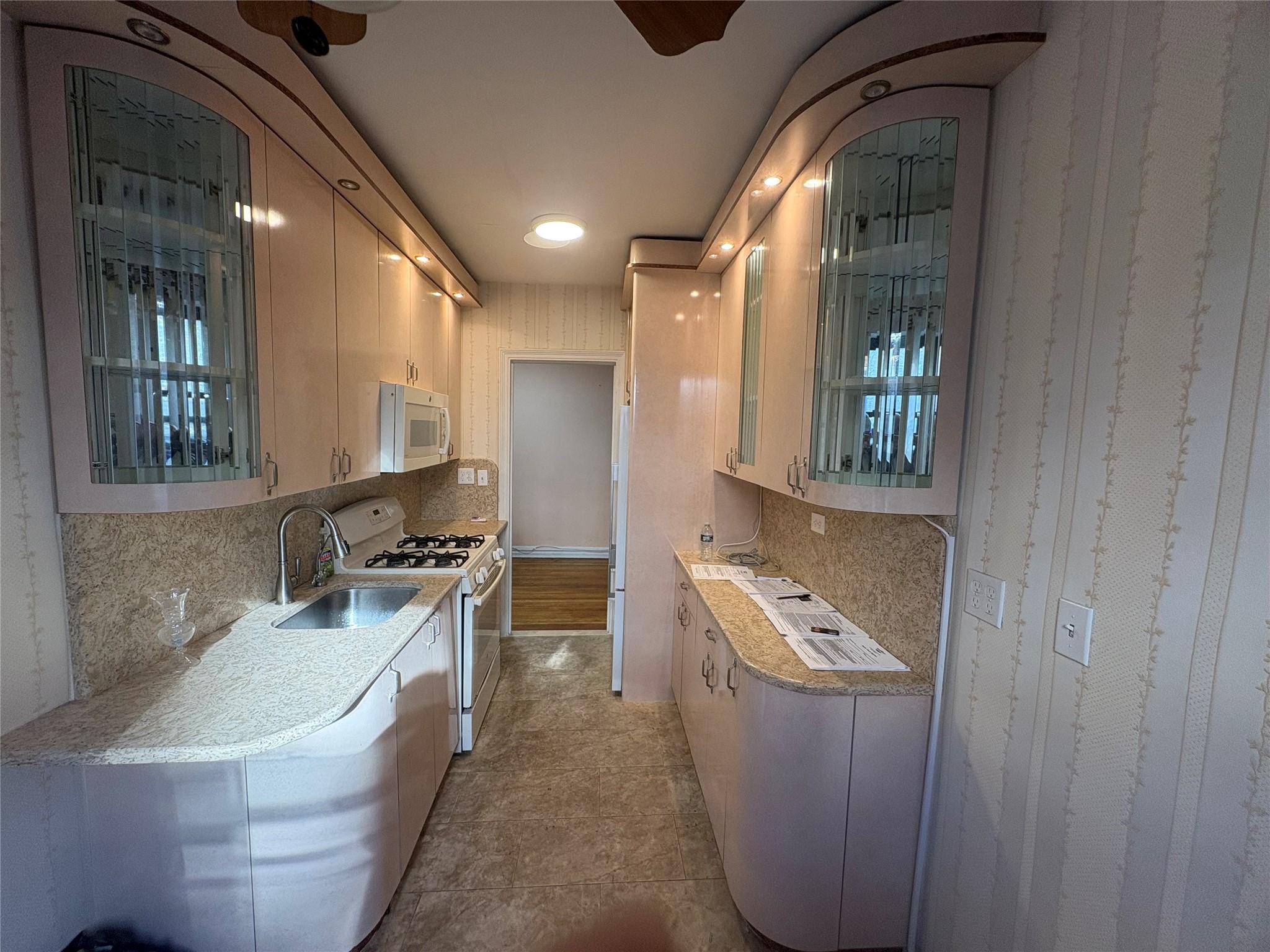 65-38 Booth Street, Unit 2F Queens, NY 11374 - Photo 8 of 13 a bathroom with a tub a sink and mirror