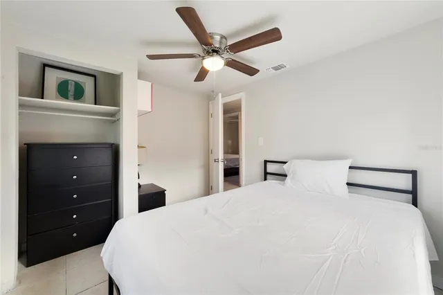 a bedroom with a large bed and a chandelier
